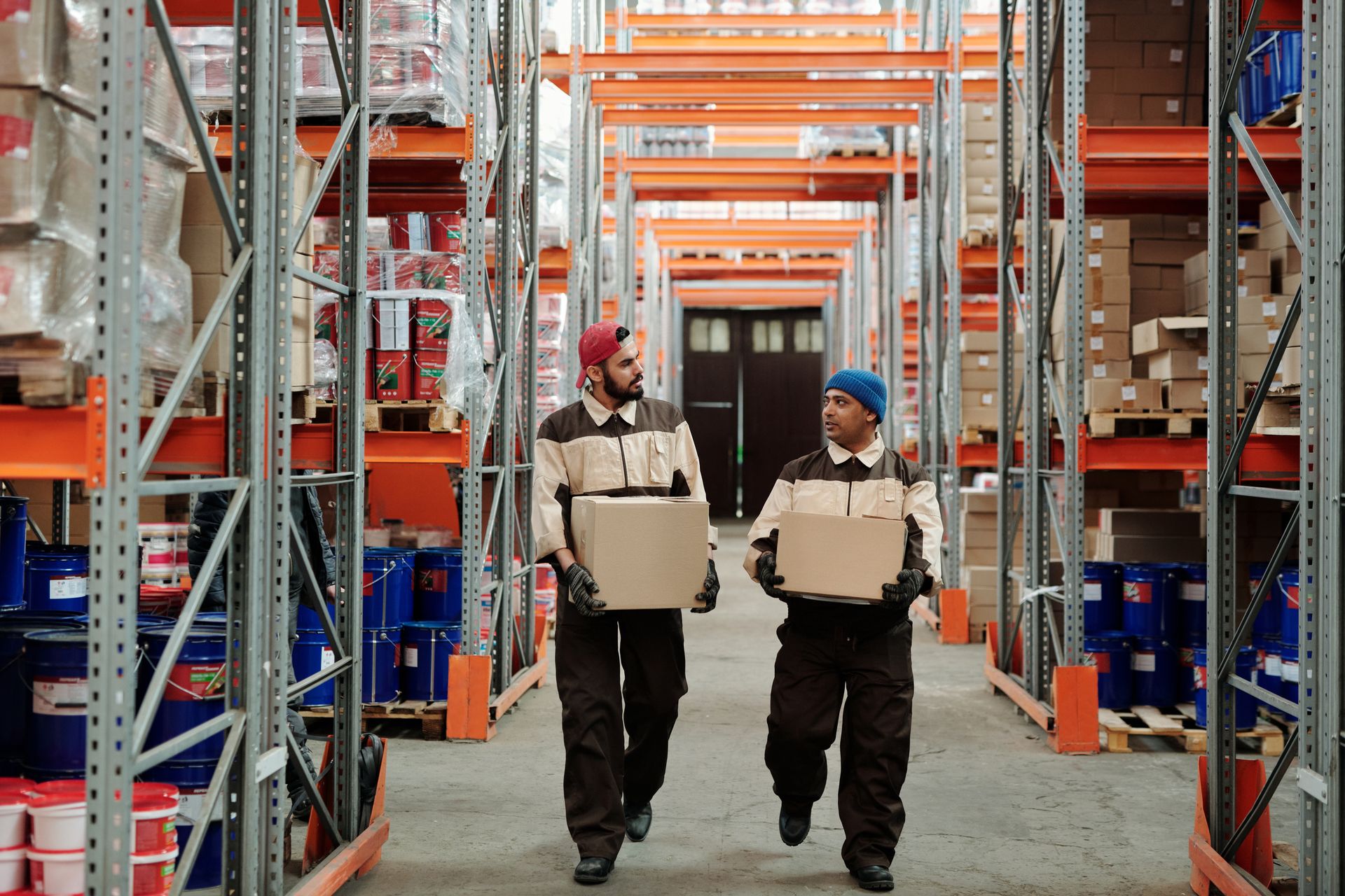 Warehouse staff carry packaged orders